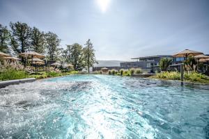 a swimming pool with blue water in a resort at Luisenhöhe - Gesundheitsresort Schwarzwald in Horben +34 photos