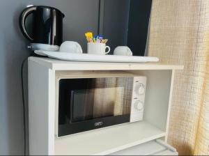 a microwave on a shelf with a plate on top at Alberta Bed and Breakfast in Pietermaritzburg