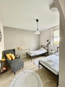 a living room with two beds and a couch at BeeApartments Żywiecka 49 in Nowy Sącz