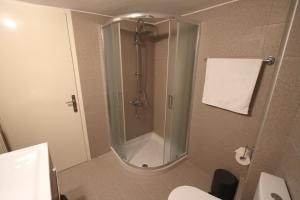 a bathroom with a shower and a toilet at Newly Renovated Central 2 Bedroom Apartment in Kozani in Kozani +16 photos