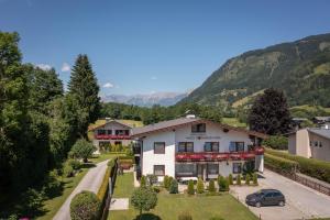 an aerial view of a house with mountains in the background at Ferienhaus am See in Zell am See