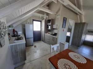 a kitchen with a refrigerator and a table in it at Manatoka Unit 3 in Jacobs Bay