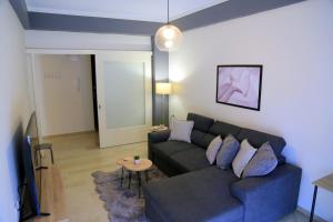 a living room with a couch and a table at Newly Renovated Central 2 Bedroom Apartment in Kozani in Kozani