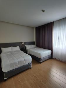 Postel nebo postele na pokoji v ubytování Altori Park Hotel