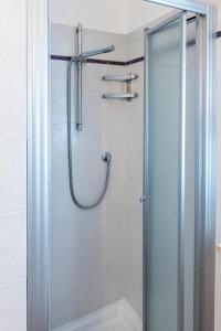 a shower with a glass door in a bathroom at Trilocale con A/C a Marcelli - M035 in Marcelli