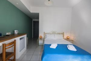 A bed or beds in a room at V-rooms in Milos Cyclades