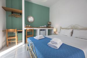 A bed or beds in a room at V-rooms in Milos Cyclades