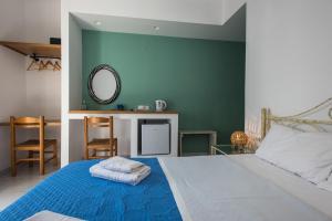 A bed or beds in a room at V-rooms in Milos Cyclades