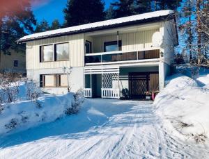 a house in the snow with a driveway at Detached house Mämmensalmi in Äänekoski