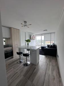 a kitchen and living room with a table and chairs at Lagunas del mar in La Serena