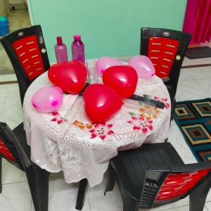 een tafel met rode hartballonnen erop bij Lara stay 2bhk appartments in Calcutta