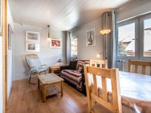 a living room with a table and a couch at Appartement La Clusaz, 3 pièces, 4 personnes - FR-1-304-46 in La Clusaz