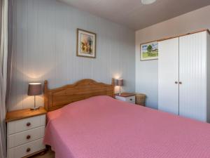 a bedroom with a bed with a pink bedspread at Appartement La Clusaz, 3 pièces, 4 personnes - FR-1-304-46 in La Clusaz