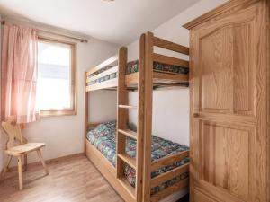 a bedroom with two bunk beds and a window at Appartement La Clusaz, 3 pièces, 6 personnes - FR-1-304-133 in La Clusaz