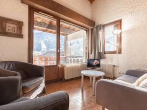 a living room with two couches and a large window at Appartement La Clusaz, 4 pièces, 8 personnes - FR-1-304-3 in La Clusaz