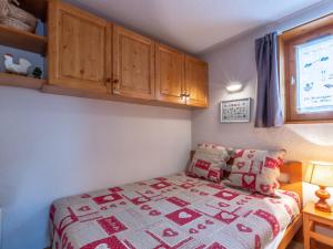 a bedroom with a bed and wooden cabinets at Appartement La Clusaz, 2 pièces, 5 personnes - FR-1-304-38 in La Clusaz