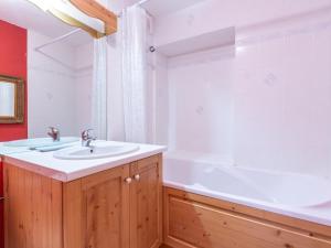 a bathroom with a sink and a bath tub at Appartement La Clusaz, 4 pièces, 6 personnes - FR-1-304-112 in La Clusaz