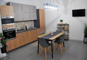 a kitchen with a table and chairs in a room at Marsala In centro in Marsala