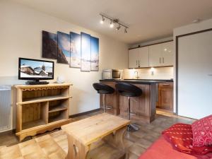 a kitchen with a table and a counter top at Studio La Clusaz, 1 pièce, 3 personnes - FR-1-304-264 in La Clusaz