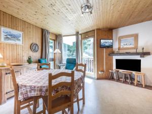 a dining room with a table and chairs and a fireplace at Appartement La Clusaz, 3 pièces, 6 personnes - FR-1-304-151 in La Clusaz