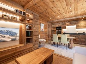 a dining room with wooden walls and a table and chairs at Appartement La Clusaz, 3 pièces, 4 personnes - FR-1-304-231 in La Clusaz