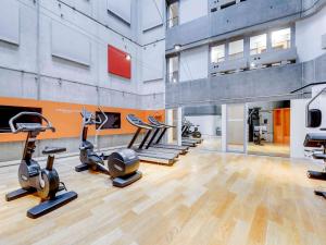 a gym with several treadmills and cardio machines at Novotel Paris Gare De Lyon in Paris