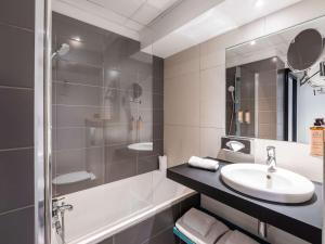 La salle de bains est pourvue d'un lavabo et d'une douche. dans l'établissement Mercure Paris Gare De Lyon TGV, à Paris