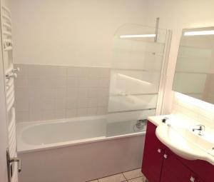 a bathroom with a tub and a sink and a shower at Gite de Amiens Poulainville in Poulainville +14 photos