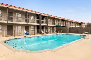 a large swimming pool in front of a building at La Quinta Inn by Wyndham San Antonio Lackland in San Antonio