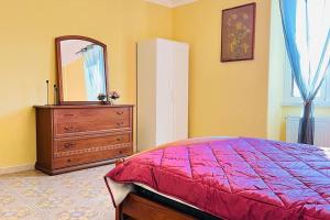 Un dormitorio con una cama, una cómoda y un espejo. en Les chats maison, en Anzio