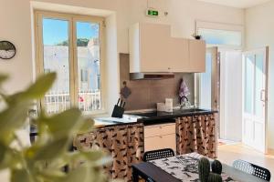Una cocina con encimera y mesa con sillas. en Les chats maison, en Anzio