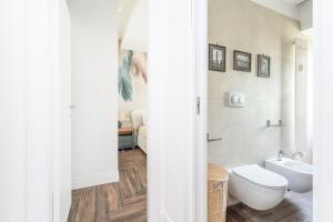 a white bathroom with a toilet and a sink at Gregory 7House Vaticano in Rome +21 photos