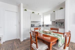 a kitchen with white cabinets and a table with a bowl on it at Gregory 7House Vaticano in Rome