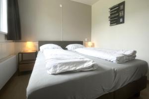 Postel nebo postele na pokoji v ubytování Aurora, Wijk de Brabander 74