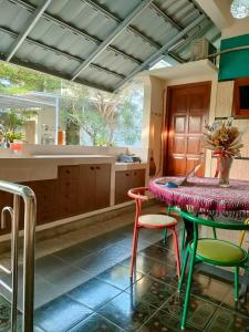 une cuisine avec une table, deux chaises et un comptoir dans l'établissement Serene Home, à Demangan