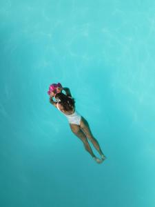 a woman swimming in the water in a pool at Seconda Stella in Jambiani