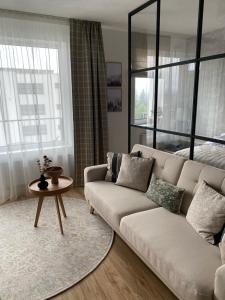 a living room with a couch and a table at Apartmán TOMI in Brezno