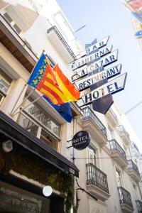 a hotel with flags on the side of a building at Hotel Alkazar in Valencia