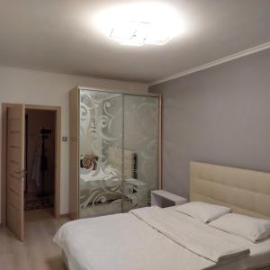 a bedroom with a bed and a glass cabinet at Теремки in Kyiv