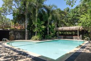 a swimming pool with a gazebo in a yard at Lotus Surf And Wellness in Ahangama