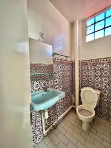 a bathroom with a sink and a toilet at Riad Le Palais in Rabat
