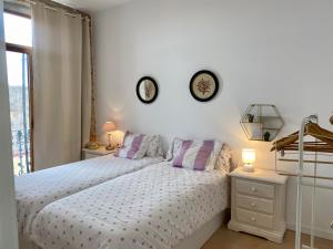 ein Schlafzimmer mit einem Bett und zwei Uhren an der Wand in der Unterkunft Apartamento en Almenara a 4 KM de la playa in Almenara
