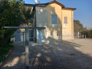 a building with a brick sidewalk in front of it at casa vacanza Cicogna in San Lazzaro di Savena