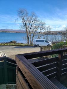 a white van parked next to a body of water at THE MOORINGS in Broadford