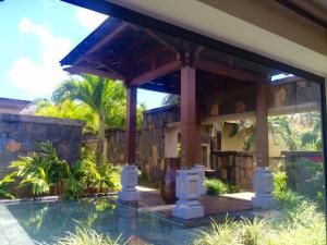 a house with a swimming pool and a pavilion at Villa Serenité in Bel Ombre