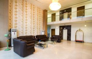 a lobby with couches and a table in a building at Rainbow International Hotel Airport Zone Shamshabad in Shamshabad