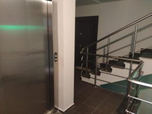 a staircase in a building with a metal railing at Central, brand new apart with parking in Blagoevgrad +39 photos