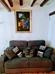 a brown couch with pillows on it in a living room at Apartament Picasso in Tarragona