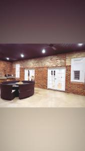 a room with ping pong tables and a brick wall at The BnB filled to the brim with character & charm! in Dubbo