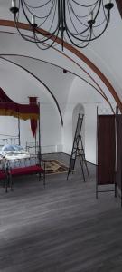 a room with a bed and a ladder in it at Templerhaus Boppard in Boppard